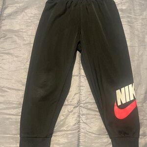 Nike Black Jogger Sweatpants with Red Swoosh and White Logo